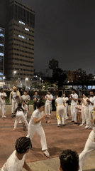 Nighttime Capoeira practice and street demonstration occur in São Paulo