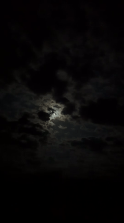 Moon illuminates passing clouds in Bulgaria night sky