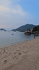 Sunset documented on Koh Tao beaches with boats offshore