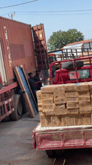 Workers load framed object onto trucks in Abuja