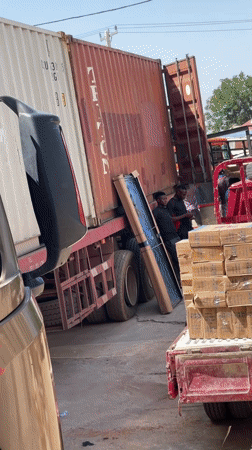 Workers load framed object onto trucks in Abuja