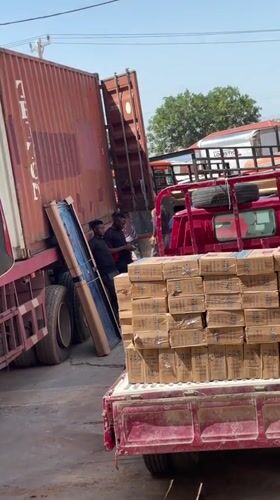 Workers load framed object onto trucks in Abuja