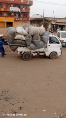 Men Push Loaded Truck on Dirt Road in Nigeria