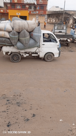 Men Push Loaded Truck on Dirt Road in Nigeria