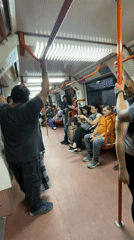 Couple embraces on Buenos Aires subway during evening commute