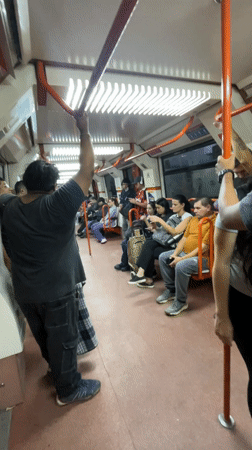 Couple embraces on Buenos Aires subway during evening commute