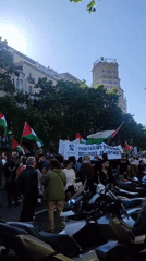 Pro-Palestinian demonstration held in urban area with solidarity messaging