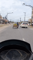 Motorcycle rider records road travel in Lhokseumawe, Indonesia