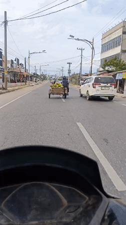 Motorcycle rider records road travel in Lhokseumawe, Indonesia