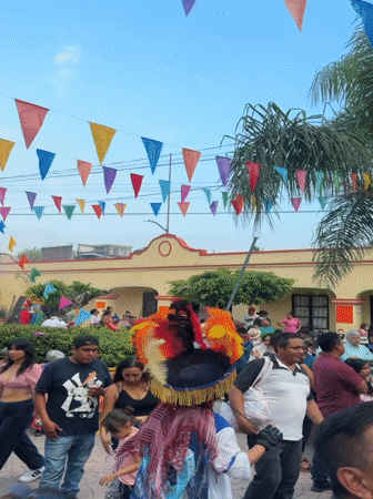 Crowded outdoor event documented in Oacalco, Mexico