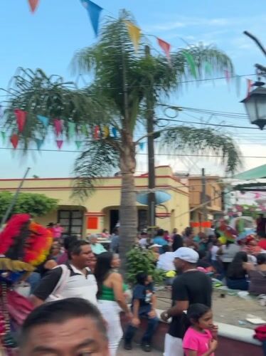 Crowded outdoor event documented in Oacalco, Mexico