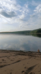 Peaceful lakeside beach afternoon documented by witnesses