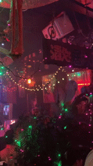 Late-night bar scene in Tel Aviv, lights and crowds.