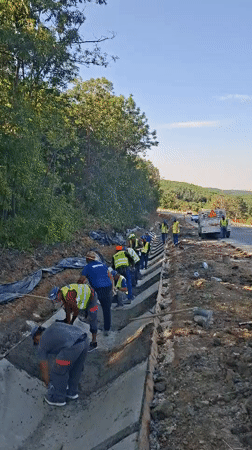 Concrete drainage channel work underway on a Hîncești roadside