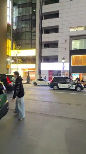 Modified luxury cars gather on Shibuya street near retail stores