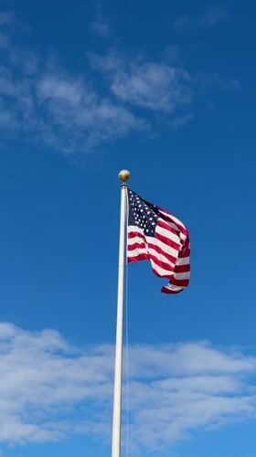 American flag flies on flagpole in Chicago