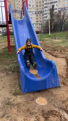 Child plays with shovel at muddy playground in Cheboksary