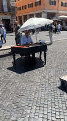 Street musician performs on piano in Rome square