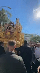 Religious procession with golden floats and brass bands in Jerez