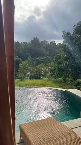 Bamboo structure with pool and interior captured in Selemadeg