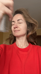 Woman uses facial spray in Kryvyi Rih morning routine