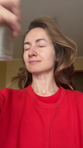 Woman uses facial spray in Kryvyi Rih morning routine