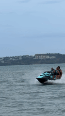 Four people jet skiing through choppy Ko Samui waters