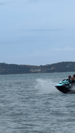 Four people jet skiing through choppy Ko Samui waters