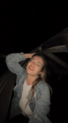 Woman dances energetically in car sunroof in Montenegro