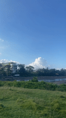 Person fishes from black sand beach in Kediri