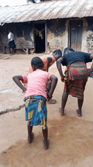 Kids dancing outdoors in a rural Akwanga courtyard