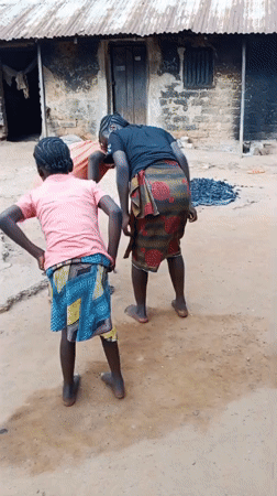 Kids dancing outdoors in a rural Akwanga courtyard