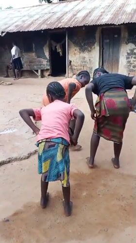Kids dancing outdoors in a rural Akwanga courtyard