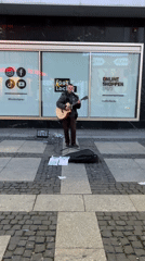 Street musician performs outside Foot Locker in Berlin