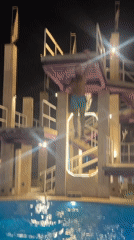 Man jumps from illuminated diving platform in Indonesia pool