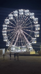 Budva's beachfront Ferris wheel lights up a summer night