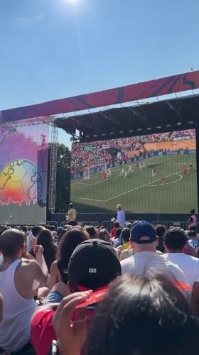 Outdoor crowd watches live soccer on a big screen in NYC
