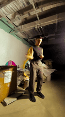 Nunchaku practice in a dimly lit unfinished room, Karaganda