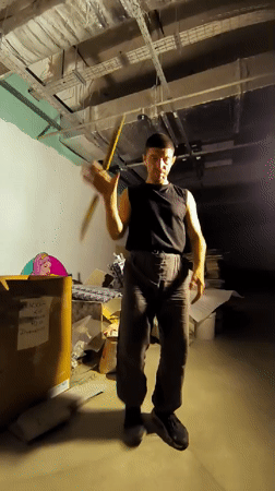 Nunchaku practice in a dimly lit unfinished room, Karaganda