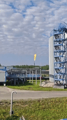 Industrial facility with burning flare documented by witness