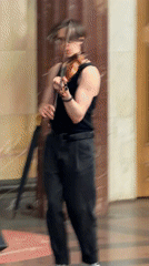 Violin duo busks in ornate subway station