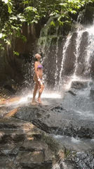Tourists enjoy waterfall activities in Gianyar, Indonesia