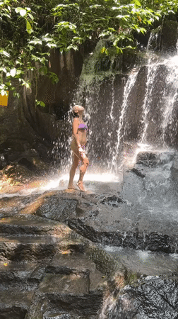 Tourists enjoy waterfall activities in Gianyar, Indonesia