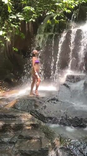Tourists enjoy waterfall activities in Gianyar, Indonesia