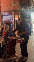 Street drummer performs on London sidewalk