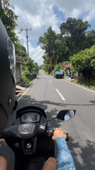 Scooter rider observed on rural road in Gianyar, Indonesia