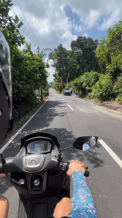 Scooter rider observed on rural road in Gianyar, Indonesia
