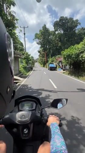 Scooter rider observed on rural road in Gianyar, Indonesia