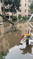 Flooding submerges playground equipment in Dhaka residential area