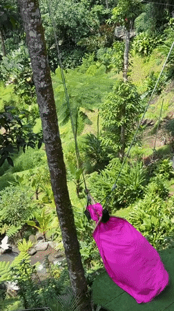 Tourists enjoy adventure activities at Tegallalang rice terraces, Bali
